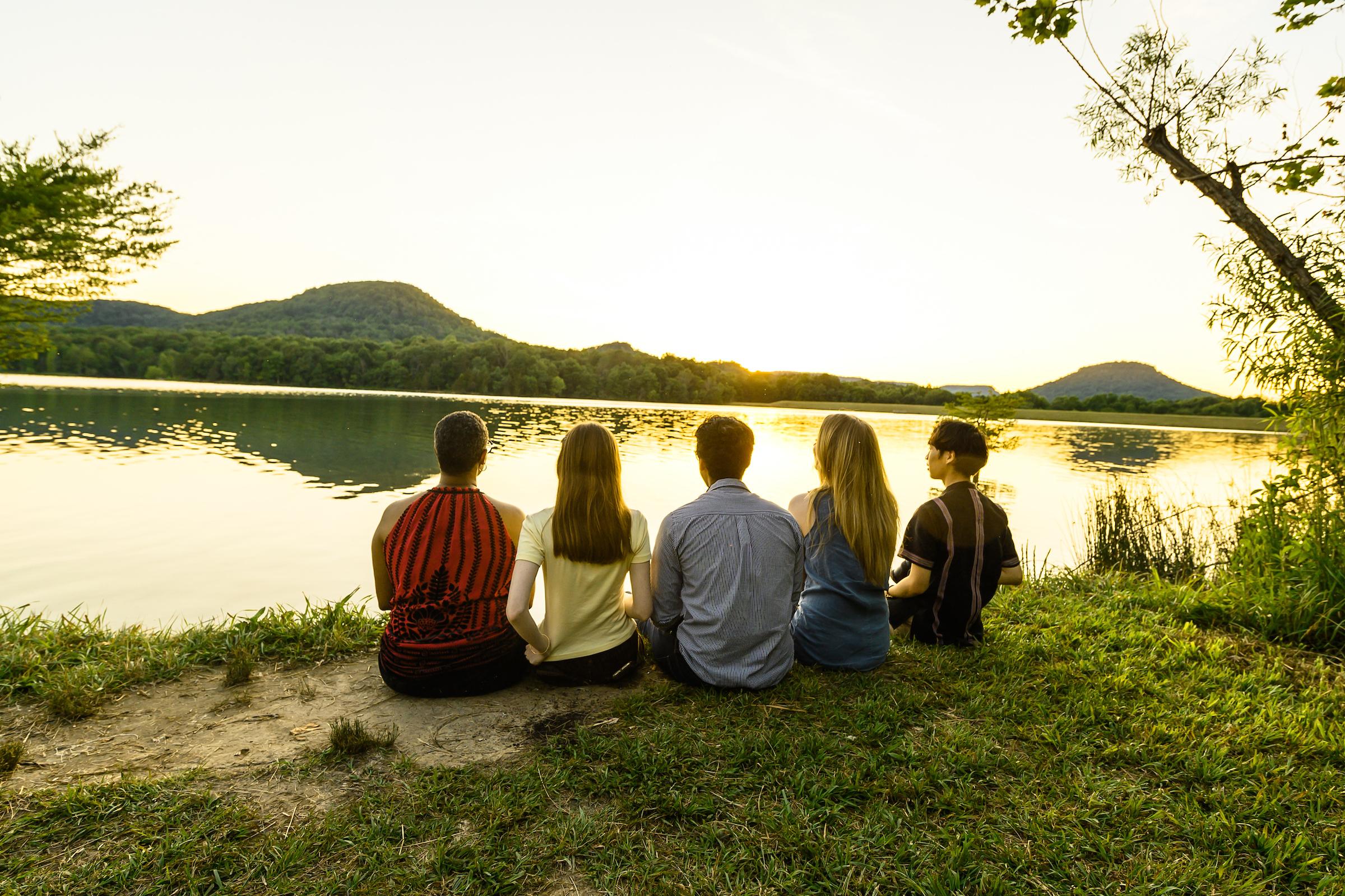A group of people looking off into the sunset at Owsley Fork Resevoir